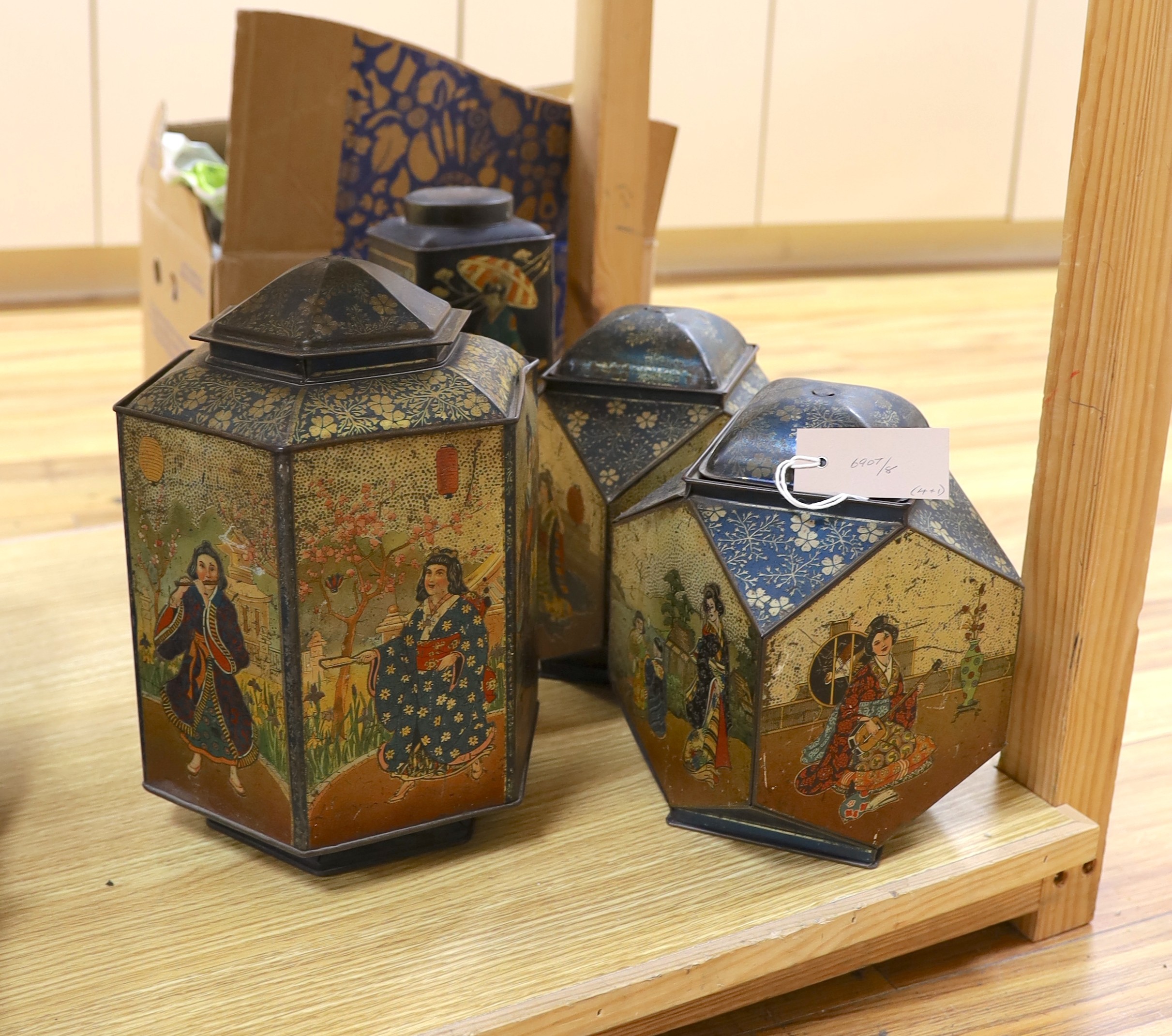 Four Japanned metal tea cannisters and a cased dressing set